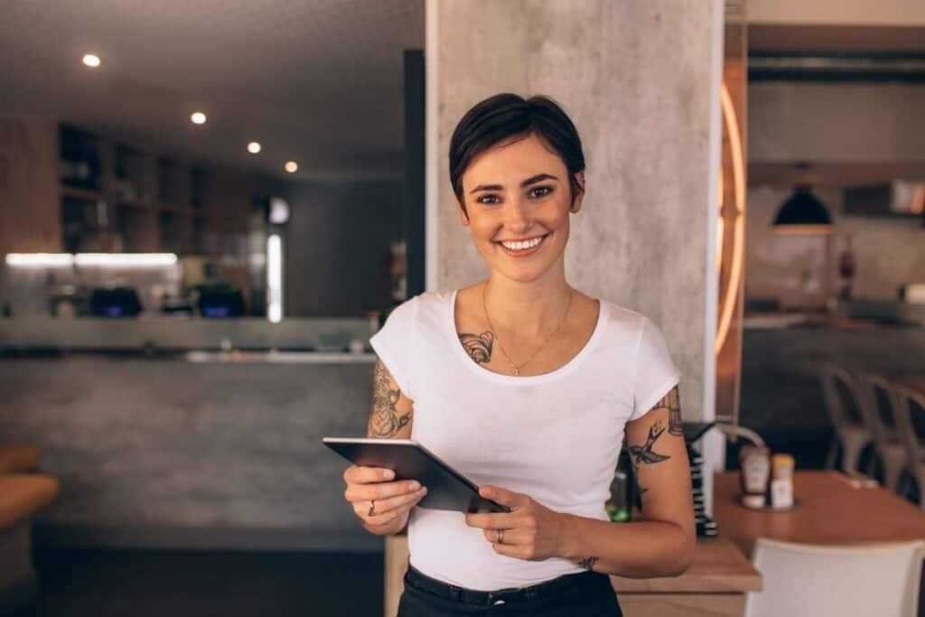 A small business owner about to open her restaurant for the day. | A featured image from "How Should I Get Started With Local SEO?" | BigCountryMarketing.com