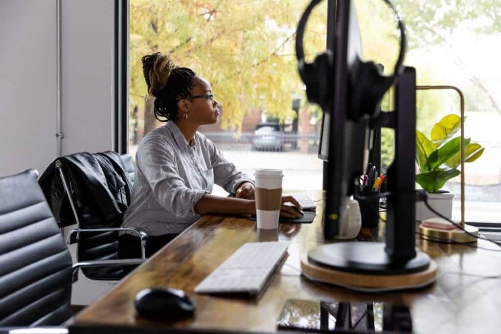 A busy small business owner working on marketing on laptop | A featured photo from "Tools and Online Services For The Modern-Day Small Business Marketer" by Big Country Marketing | BigCountryMarketing.com