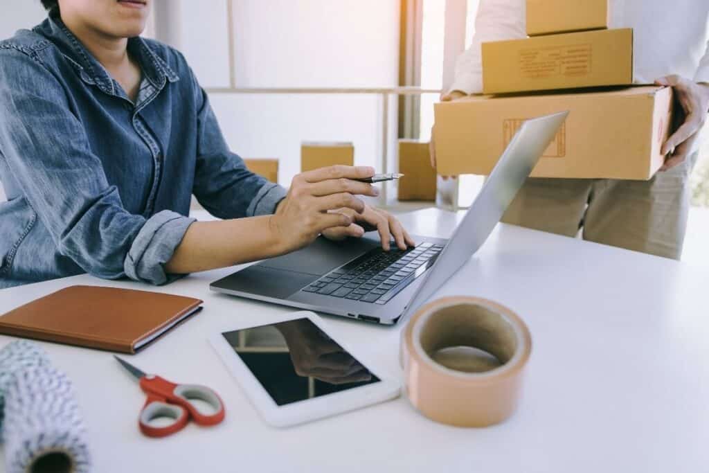 A busy small business owner working on marketing on laptop | A featured photo from "Tools and Online Services For The Modern-Day Small Business Marketer" by Big Country Marketing | BigCountryMarketing.com