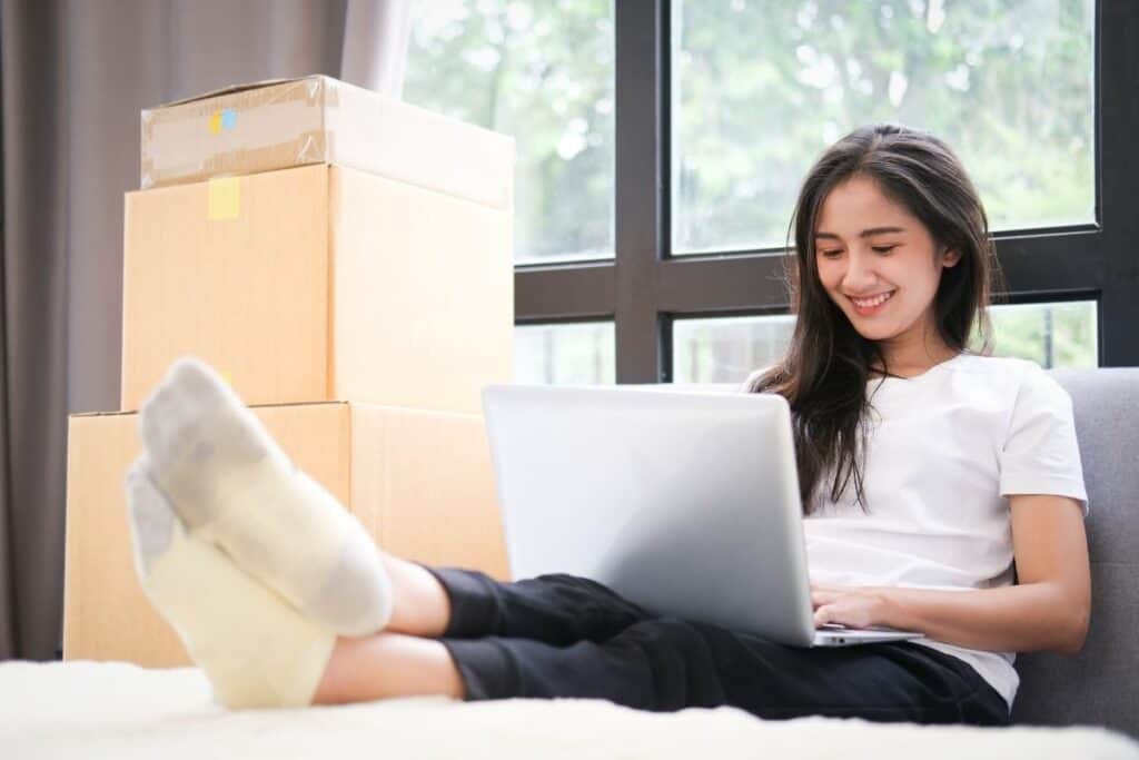 A small business owner on a laptop with her feet up, doing a bit of digital marketing for her online brand | a featured image on "How Do I Start Digital Marketing for My Business?" by Big Country Marketing | www.bigcountrymarketing.com