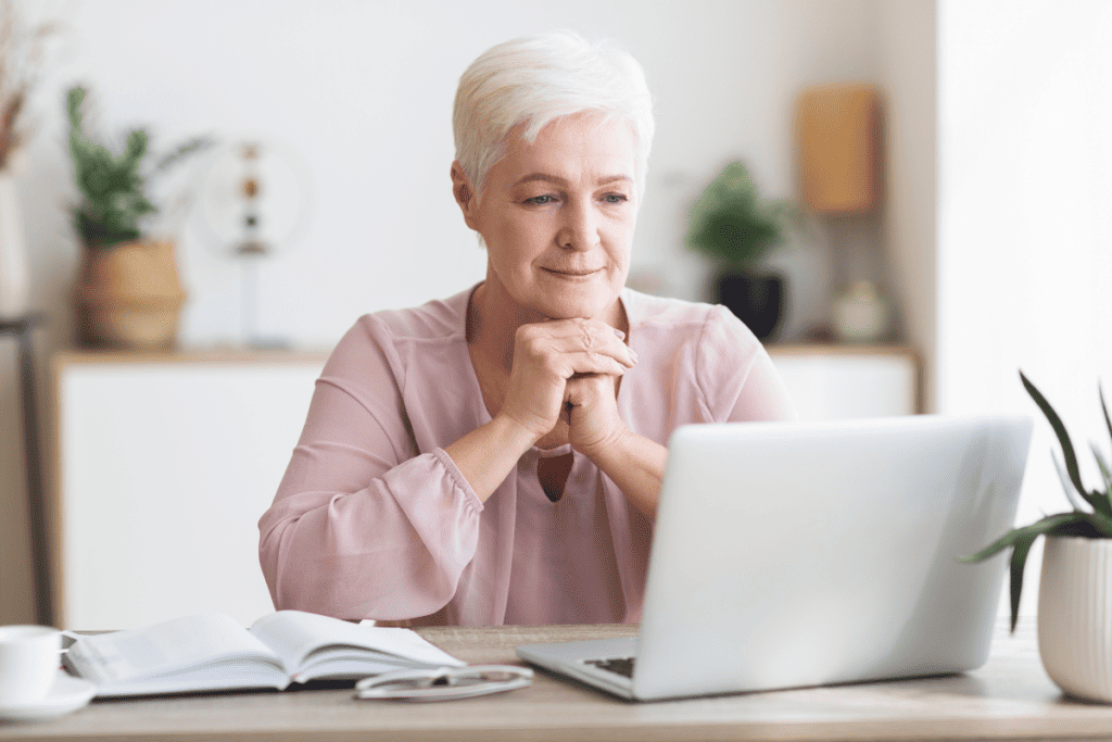 elderly business owner on a laptop.